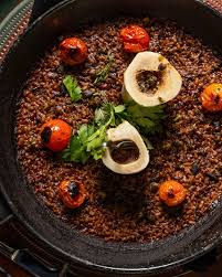 Sra. Martinez signature dishes Oxtail Paella, Fried Eggplant Chips, Pan Con Tomate, and Saffron Lemon Roasted Chicken